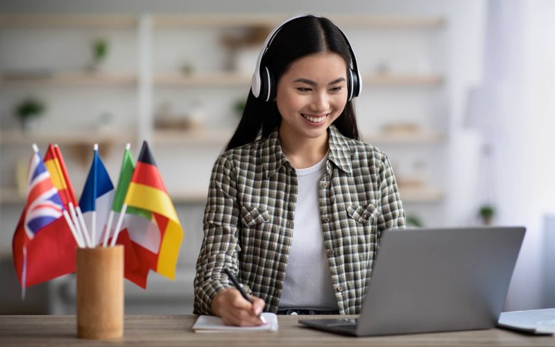 happy-asian-woman-learning-foreign-language-online.jpg